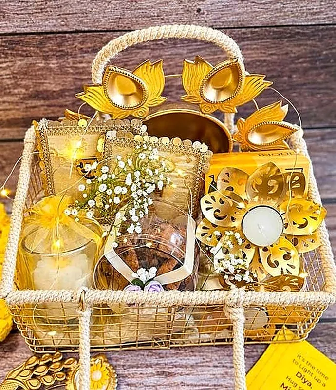 Shubhlabh — Stunning gilded wire basket featuring carved lotus urli, diyas & choco chip cookies